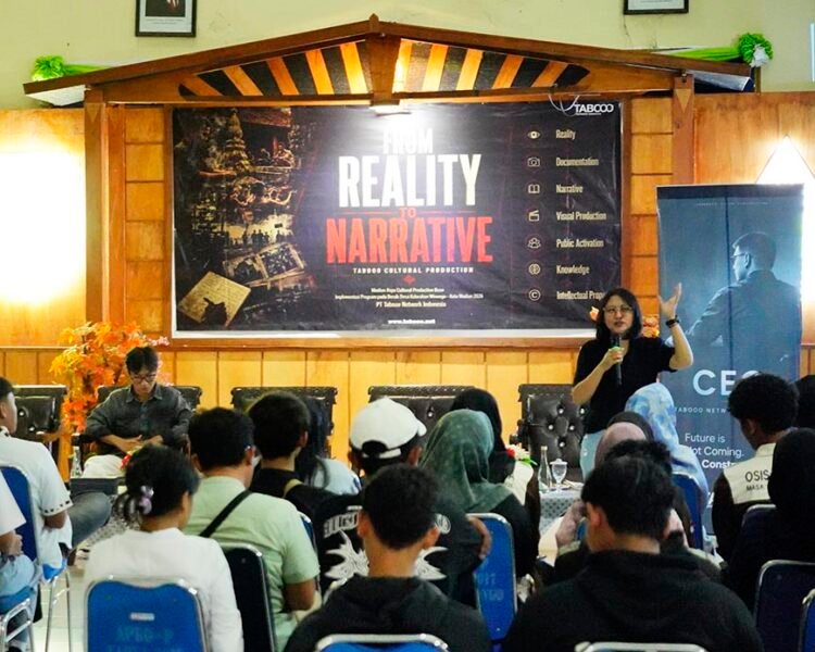 Presenter speaks into a microphone at a conference stage with a large 'From Reality to Narrative' banner behind him/her.